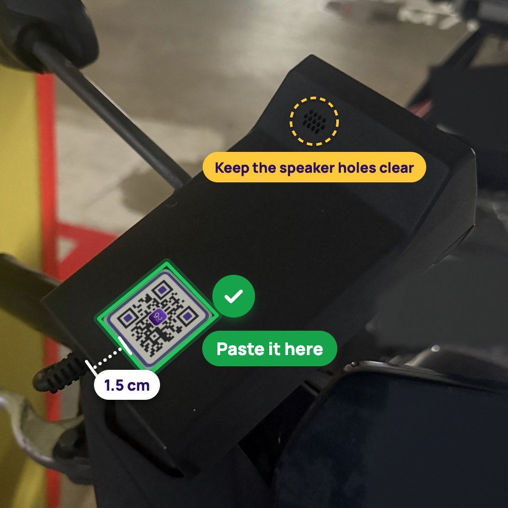 A bike’s OBU on its handlebars, with a GoRent QR sticker near the bottom of its face, straight and clear of the speaker holes near the top